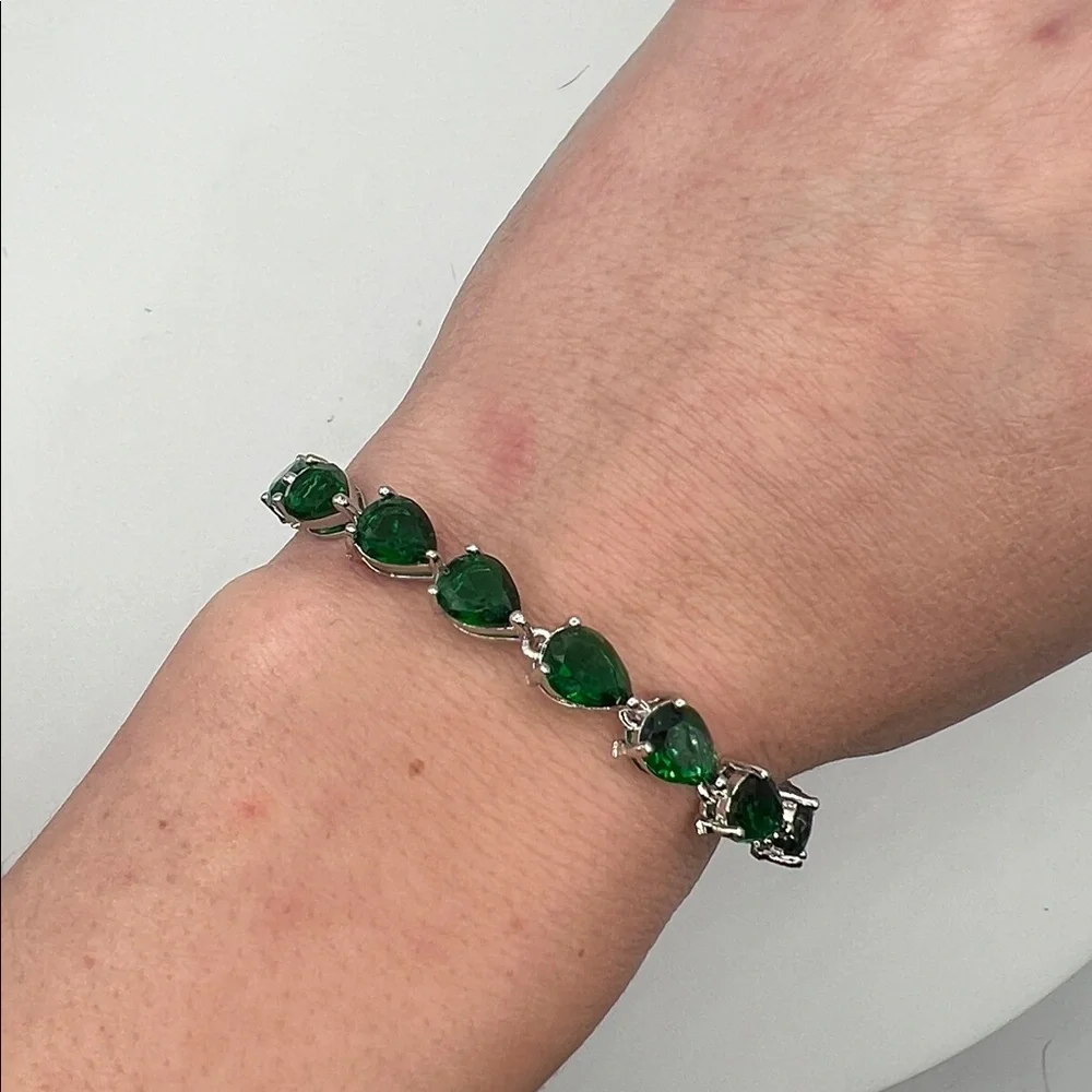198. White Gold Plated Bracelet with Pear Shaped Emeralds 7”